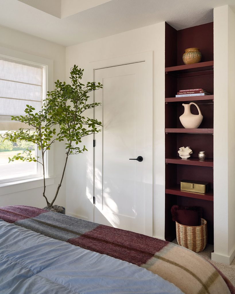Styled corner with built-in shelving, decor, and natural light in Drew Lane home