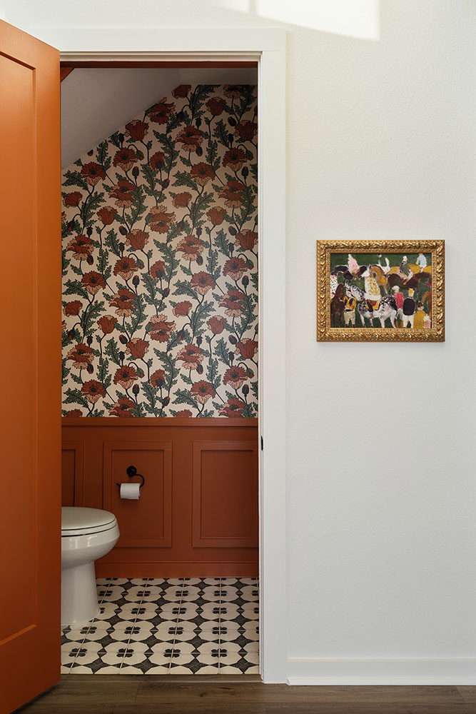 Bold bathroom with floral wallpaper and patterned tile in Drew Lane model home