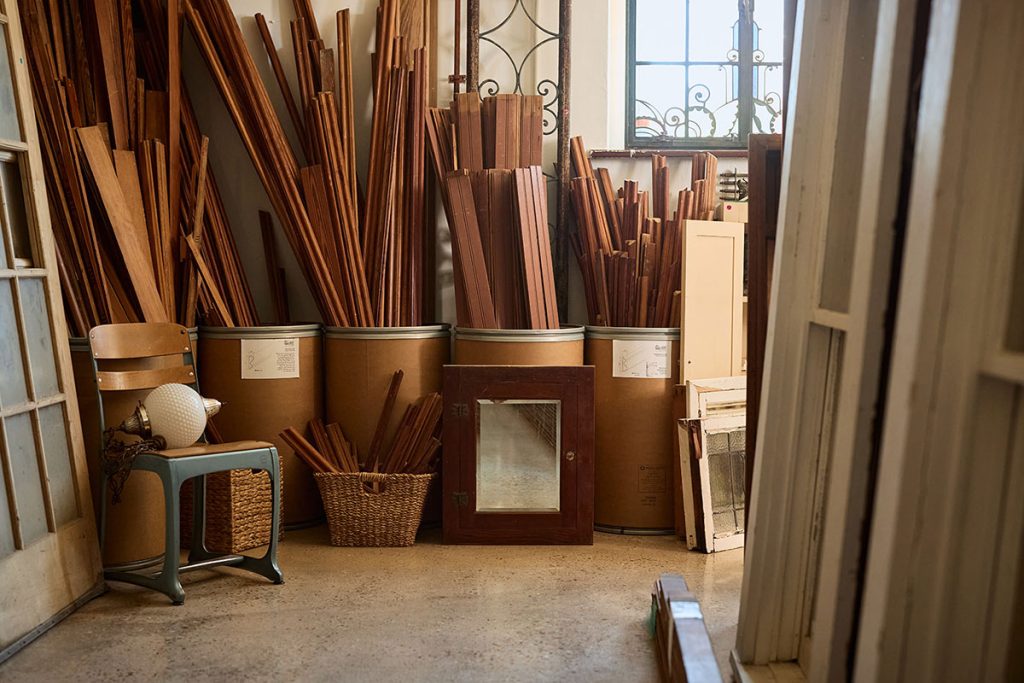 Stacks of reclaimed wood and salvaged materials inside the shop