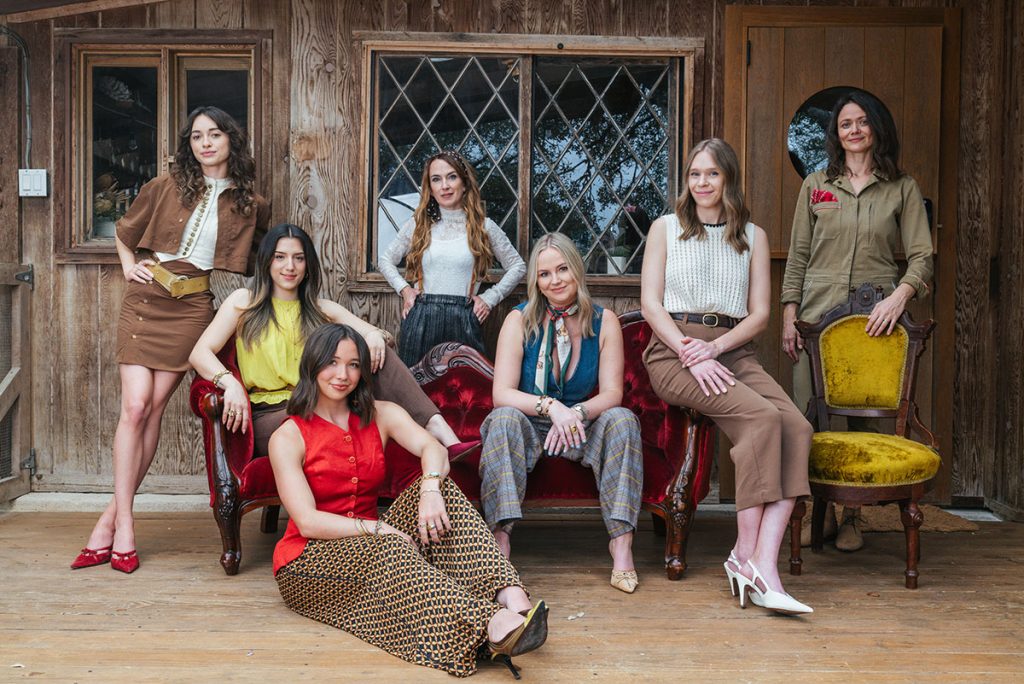 Kim Lewis Design team group portrait in front of rustic wood backdrop